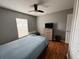 Well-lit bedroom with a ceiling fan, dresser, and a window view at 824 San Pedro Ct, Kissimmee, FL 34758