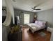 Comfortable bedroom with wood floors, ceiling fan, and decorative shelving at 824 San Pedro Ct, Kissimmee, FL 34758
