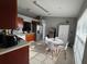 Well-lit kitchen features stainless steel appliances, tile flooring, and a cozy dining nook at 824 San Pedro Ct, Kissimmee, FL 34758