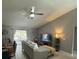 Living area featuring vaulted ceilings, a ceiling fan, and sliding glass doors to the patio at 824 San Pedro Ct, Kissimmee, FL 34758