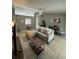 Spacious living area with tile floors, a ceiling fan, and bar seating in the background at 824 San Pedro Ct, Kissimmee, FL 34758