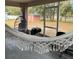 Cozy screened patio with a swing chair, hammock, and a view of the backyard at 824 San Pedro Ct, Kissimmee, FL 34758