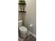 Cozy half-bath with decorative shelving, neutral walls, and a functional layout at 1060 Rock Harbor Ave, Orlando, FL 32828
