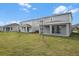 Spacious backyard featuring a manicured lawn and covered patio at 1455 August Gray Dr, Kissimmee, FL 34744