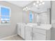 Large bathroom features dual sinks, modern fixtures, and a glass-enclosed shower at 1455 August Gray Dr, Kissimmee, FL 34744