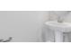 Neutral-colored bathroom featuring a white pedestal sink with towel rack and faucet at 1455 August Gray Dr, Kissimmee, FL 34744