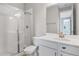 Bathroom featuring a glass-enclosed shower, white vanity, and modern fixtures at 1455 August Gray Dr, Kissimmee, FL 34744
