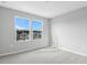 Bright bedroom featuring neutral carpet, fresh paint, and double hung windows for natural light at 1455 August Gray Dr, Kissimmee, FL 34744