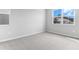 Carpeted room with two windows and neutral color palette offers a relaxing space at 1455 August Gray Dr, Kissimmee, FL 34744