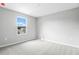 Bright bedroom featuring neutral carpet, fresh paint, and a double hung window for natural light at 1455 August Gray Dr, Kissimmee, FL 34744