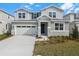 Charming two-story home with a two-car garage and well-maintained landscaping at 1455 August Gray Dr, Kissimmee, FL 34744