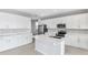 Bright, spacious kitchen with white cabinets, stainless steel appliances and island at 1455 August Gray Dr, Kissimmee, FL 34744