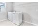 New laundry room featuring washer, dryer, tile floors, shelving and a light neutral paint at 1455 August Gray Dr, Kissimmee, FL 34744