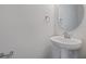 Simple bathroom with pedestal sink and round mirror at 1461 August Gray Dr, Kissimmee, FL 34744