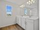 Double vanity bathroom with a large mirror and a shower at 1461 August Gray Dr, Kissimmee, FL 34744