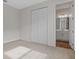 Bright bedroom with carpeting, double doors to closet, and ensuite bathroom at 1461 August Gray Dr, Kissimmee, FL 34744