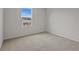 Spacious bedroom with neutral decor and a window at 1461 August Gray Dr, Kissimmee, FL 34744