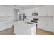 Modern kitchen with white cabinets, quartz countertops, and stainless steel appliances at 1461 August Gray Dr, Kissimmee, FL 34744