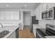 Modern kitchen with white cabinets, stainless steel appliances and an island at 1461 August Gray Dr, Kissimmee, FL 34744