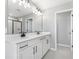 Elegant bathroom with a double sink vanity, modern fixtures, and a glass-enclosed shower at 1479 August Gray Dr, Kissimmee, FL 34744