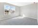 Bright bedroom with carpet floors, two windows, and neutral walls at 1479 August Gray Dr, Kissimmee, FL 34744