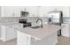 Bright kitchen featuring white cabinetry, stainless steel appliances, and quartz countertops at 1479 August Gray Dr, Kissimmee, FL 34744