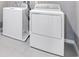 Modern laundry room featuring new washer and dryer units with tile flooring at 1479 August Gray Dr, Kissimmee, FL 34744