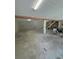 Unfinished basement featuring concrete block walls, support beams, concrete floors, and a staircase leading to the upper level at 2728 Adair Rd, Davenport, FL 33837