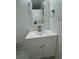 Bathroom featuring a white vanity, modern faucet, and a uniquely framed mirror at 2728 Adair Rd, Davenport, FL 33837