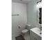 Clean bathroom featuring a toilet, vanity with sink, and decorative mirror at 2728 Adair Rd, Davenport, FL 33837