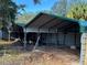 Exterior metal carports and surrounding treed landscape at 2728 Adair Rd, Davenport, FL 33837