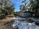 Side view of the metal carports and treed landscape at 2728 Adair Rd, Davenport, FL 33837