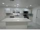 Kitchen featuring white cabinets, island, stainless steel appliances and tile flooring at 2728 Adair Rd, Davenport, FL 33837