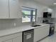Updated kitchen with quartz countertops, stainless appliances and a window view at 2728 Adair Rd, Davenport, FL 33837