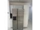 Stainless steel refrigerator with water dispenser and white cabinets in kitchen at 2728 Adair Rd, Davenport, FL 33837
