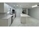 Kitchen showcasing the sink, island, white cabinets and stainless steel appliances at 2728 Adair Rd, Davenport, FL 33837