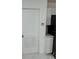 Kitchen entryway featuring white door, tile flooring, and white cabinets at 2728 Adair Rd, Davenport, FL 33837