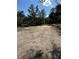 View of a large homesite featuring a sandy lot ready for construction, accented by mature trees and blue skies at 2728 Adair Rd, Davenport, FL 33837