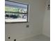 Bright laundry room with a window overlooking the backyard and white walls at 2728 Adair Rd, Davenport, FL 33837
