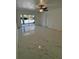 Spacious living room with white tile floors, ceiling fan, and sliding glass doors leading to the backyard at 2728 Adair Rd, Davenport, FL 33837
