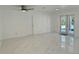 Light-filled living room boasting white walls, marble floors, and backyard access at 2728 Adair Rd, Davenport, FL 33837