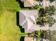 An aerial view of a single Gathering home that features a tile roof and a green manicured lawn at 3643 Weatherfield Dr, Kissimmee, FL 34746
