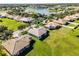 An aerial view of the neighborhood showcasing lush landscaping and a community lake at 3643 Weatherfield Dr, Kissimmee, FL 34746