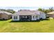 Expansive backyard featuring a covered patio, lush green lawn, and privacy at 3643 Weatherfield Dr, Kissimmee, FL 34746