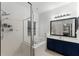 Bathroom featuring a glass-enclosed shower, soaking tub, and dual sink vanity at 3643 Weatherfield Dr, Kissimmee, FL 34746