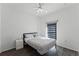 Bright bedroom with modern ceiling fan, window with shades and black metal bed frame at 3643 Weatherfield Dr, Kissimmee, FL 34746