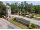 Beautiful community entrance featuring a decorative tower, signage and colorful landscaping at 3643 Weatherfield Dr, Kissimmee, FL 34746