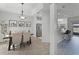 Bright, modern dining area with stylish light fixture, stainless appliances, and breakfast bar at 3643 Weatherfield Dr, Kissimmee, FL 34746