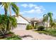 Charming home showcasing a brick driveway, lush landscaping, and a well-maintained lawn at 3643 Weatherfield Dr, Kissimmee, FL 34746