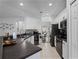 Bright kitchen with black appliances, stone countertops, and an attached dining area at 3643 Weatherfield Dr, Kissimmee, FL 34746
